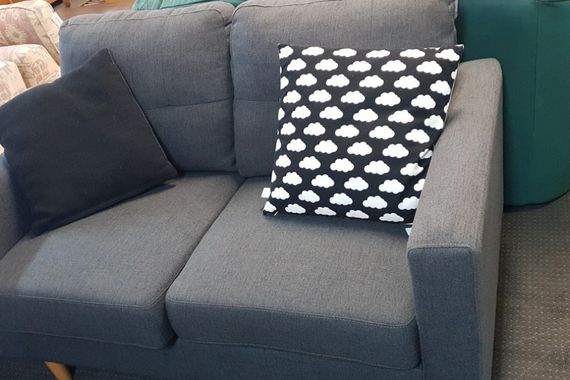 blue-grey two-seater sofa with cushions